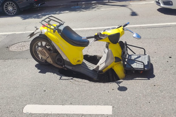Un scuter s-a “scufundat” pe o stradă din Cluj: ,,Bine că e sănătos omul, dar gaura aia putea provoca daune serioase’’